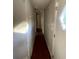 View of long narrow hallway with wood floors at 10542 Helena St, New Port Richey, FL 34654