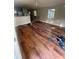 Living room with wood laminate flooring, ceiling fan, and natural light at 10542 Helena St, New Port Richey, FL 34654
