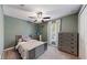 Cozy bedroom with full-size bed, dresser, and ceiling fan at 15407 Miller Creek Dr, Sun City Center, FL 33573