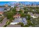 Aerial shot of a home nestled among lush trees with a screened-in pool, showing its proximity to downtown in a beautiful setting at 45 Adalia Ave, Tampa, FL 33606