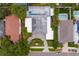 Aerial view of a home with a circular driveway, mature landscaping, and private backyard with a screened pool at 45 Adalia Ave, Tampa, FL 33606