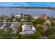 A captivating aerial view showcases waterfront homes with screened-in pools, surrounded by lush greenery and well-maintained landscapes at 45 Adalia Ave, Tampa, FL 33606
