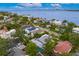 An inviting aerial perspective highlights waterfront homes with inviting screened-in pools, showcasing a serene and luxurious community lifestyle at 45 Adalia Ave, Tampa, FL 33606