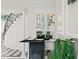 Stylish bar area with custom cabinetry, glass shelving, and black and white tile floors at 45 Adalia Ave, Tampa, FL 33606