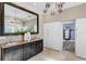 This bathroom showcases a dual sink vanity with granite counters, a large mirror, and ample storage at 45 Adalia Ave, Tampa, FL 33606