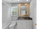 Elegant bathroom featuring a marble vanity, framed mirror and a shower-tub combination at 45 Adalia Ave, Tampa, FL 33606