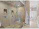 Spa-like bathroom features a glass-enclosed shower with dual shower heads and a comfortable built-in bench at 45 Adalia Ave, Tampa, FL 33606