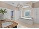 Bathroom boasts granite counters, a large tub, a chandelier, and abundant cabinet space for a luxurious experience at 45 Adalia Ave, Tampa, FL 33606