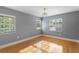 Bright bedroom with natural light, hardwood floors, and charming chandelier, offering a serene retreat at 45 Adalia Ave, Tampa, FL 33606