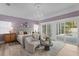 Luxurious bedroom featuring a chandelier, seating area, and access to an outdoor pool area, perfect for relaxation at 45 Adalia Ave, Tampa, FL 33606