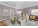 Bright bedroom showcasing a chandelier, seating area, and a large bed, creating a cozy and inviting space at 45 Adalia Ave, Tampa, FL 33606