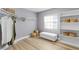 Bright walk-in closet offers ample storage with shelving and hanging space, complete with a comfortable bench at 45 Adalia Ave, Tampa, FL 33606