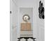 Elegant entryway features black and white tile, leading to a console table with mirror in a bright hallway at 45 Adalia Ave, Tampa, FL 33606