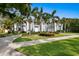 Elegant two-story home featuring white columns, lush landscaping, and a circular driveway at 45 Adalia Ave, Tampa, FL 33606