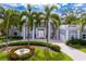 Stately two-story home with white columns, mature palms, and a circular driveway at 45 Adalia Ave, Tampa, FL 33606