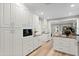 Bright kitchen with stainless steel appliances, white cabinetry, and stone countertops at 45 Adalia Ave, Tampa, FL 33606