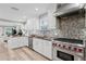 Gourmet kitchen with stainless steel appliances, white cabinetry, and a center island at 45 Adalia Ave, Tampa, FL 33606