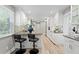 Eat-in kitchen with bright white cabinets, a breakfast bar and stone countertops at 45 Adalia Ave, Tampa, FL 33606