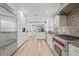Gourmet kitchen with stainless steel appliances, white cabinetry, and a center island at 45 Adalia Ave, Tampa, FL 33606