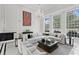 Bright, open living room boasts large windows, a fireplace, and a stunning crystal chandelier at 45 Adalia Ave, Tampa, FL 33606