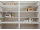 Well-organized pantry with white shelving and stylish storage baskets, perfect for kitchen organization at 45 Adalia Ave, Tampa, FL 33606