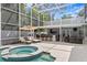 Gorgeous pool area featuring a spa, lounge chairs, and outdoor bar, ideal for entertainment and leisure at 45 Adalia Ave, Tampa, FL 33606