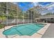 Beautiful screened pool with jacuzzi, lounge chairs, and outdoor bar, perfect for relaxation and entertainment at 45 Adalia Ave, Tampa, FL 33606