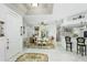 Bright dining room with white table and chairs, and decorative wall accents at 8048 Sanguinelli Rd, Land O Lakes, FL 34637