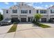 Three-unit townhome building with parking and landscaping at 10985 Brightleaf Ct, Riverview, FL 33569