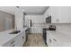 Modern kitchen with white cabinets, stainless steel appliances, and quartz countertops at 10985 Brightleaf Ct, Riverview, FL 33569