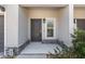 Townhome entrance with covered porch and stone accents at 10985 Brightleaf Ct, Riverview, FL 33569