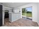 Modern kitchen with gray cabinets, stainless steel appliances, and a breakfast bar at 10209 Summerview Cir, Riverview, FL 33578