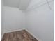 White closet with wire shelving and wood-look flooring at 10209 Summerview Cir, Riverview, FL 33578