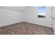 Spacious bedroom featuring a large window and wood-look floors at 10209 Summerview Cir, Riverview, FL 33578