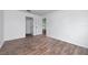 Spacious bedroom with wood-look floors and access to other rooms at 10209 Summerview Cir, Riverview, FL 33578