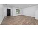 Open living area with hardwood floors, a black front door and an open staircase at 10209 Summerview Cir, Riverview, FL 33578