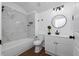 Modern bathroom with white vanity, marble shower, and wood-look floors at 10209 Summerview Cir, Riverview, FL 33578