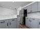 Modern kitchen with gray cabinets, marble countertops, and stainless steel refrigerator at 10209 Summerview Cir, Riverview, FL 33578