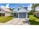 Newly built home with gray garage and well-maintained lawn at 10209 Summerview Cir, Riverview, FL 33578