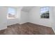 Bright bedroom with wood-look floors and two windows at 10209 Summerview Cir, Riverview, FL 33578