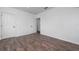 Simple bedroom with wood-look floors and an additional door at 10209 Summerview Cir, Riverview, FL 33578
