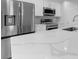 Modern kitchen features quartz countertops and stainless steel appliances at 10061 Gulfstream Blvd, Englewood, FL 34224