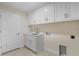 Bright laundry room with white cabinets and countertop at 10061 Gulfstream Blvd, Englewood, FL 34224