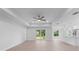 Open living room with sliding glass doors to the backyard at 10061 Gulfstream Blvd, Englewood, FL 34224