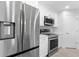 Modern kitchen with stainless steel refrigerator and range at 10061 Gulfstream Blvd, Englewood, FL 34224