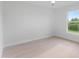 Bright bedroom with wood-look flooring and a large window at 10061 Gulfstream Blvd, Englewood, FL 34224