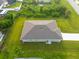 Rear view of the house showing the backyard and roofline at 10061 Gulfstream Blvd, Englewood, FL 34224