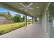 Covered patio with ceiling fan, overlooking the backyard at 10061 Gulfstream Blvd, Englewood, FL 34224