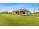 Spacious backyard with a covered patio and lush lawn at 10061 Gulfstream Blvd, Englewood, FL 34224
