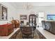 Elegant dining room with glass table, chandelier, and dark brown chairs at 1029 Seagrape Dr, Ruskin, FL 33570